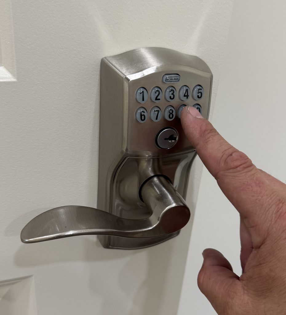 Residential locksmith servicing a keypad door lock
