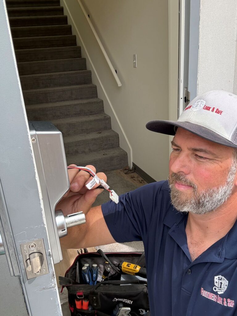 Commercial locksmith servicing a business door lock