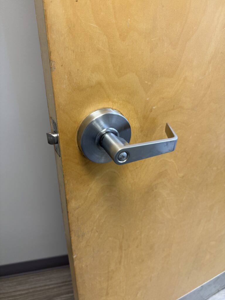 New bathroom privacy lever installed on a wooden door in Tulsa