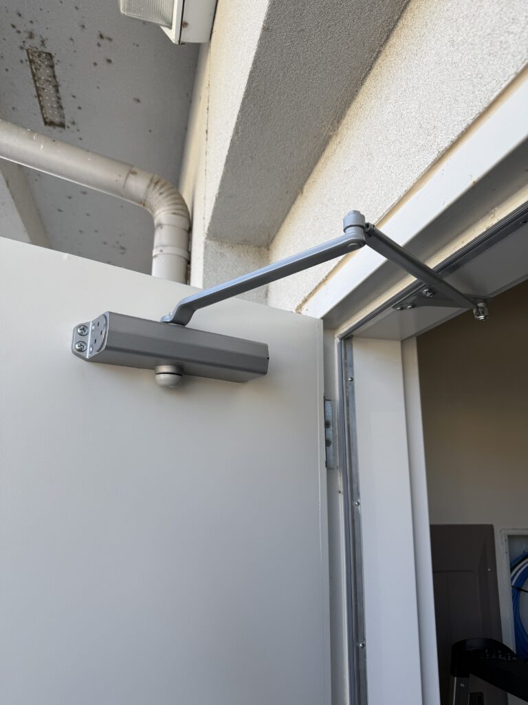 New door closer installed on a commercial suite’s back door in Bixby