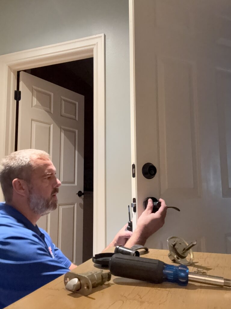 Fortress Lock & Safe locksmith repairing the entry lever on the door to the garage in Broken Arrow