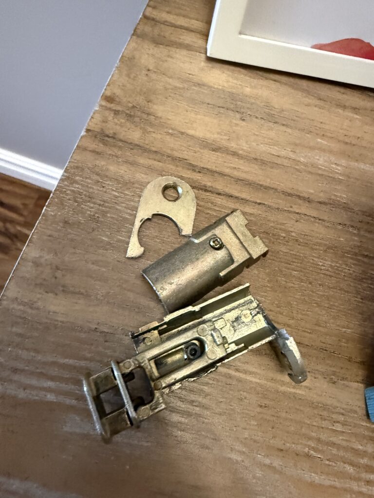 Removed spring latch and lock components during front door latch replacement in Broken Arrow