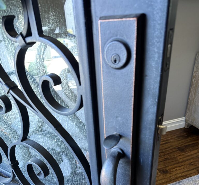 Handle set on a decorative metal front door during spring latch replacement in Broken Arrow