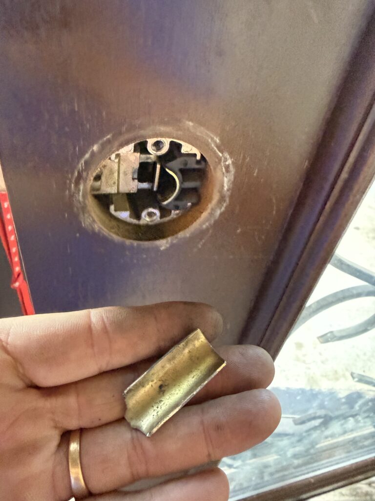 Front door lock with the interior lever removed during spring assembly repair in Broken Arrow